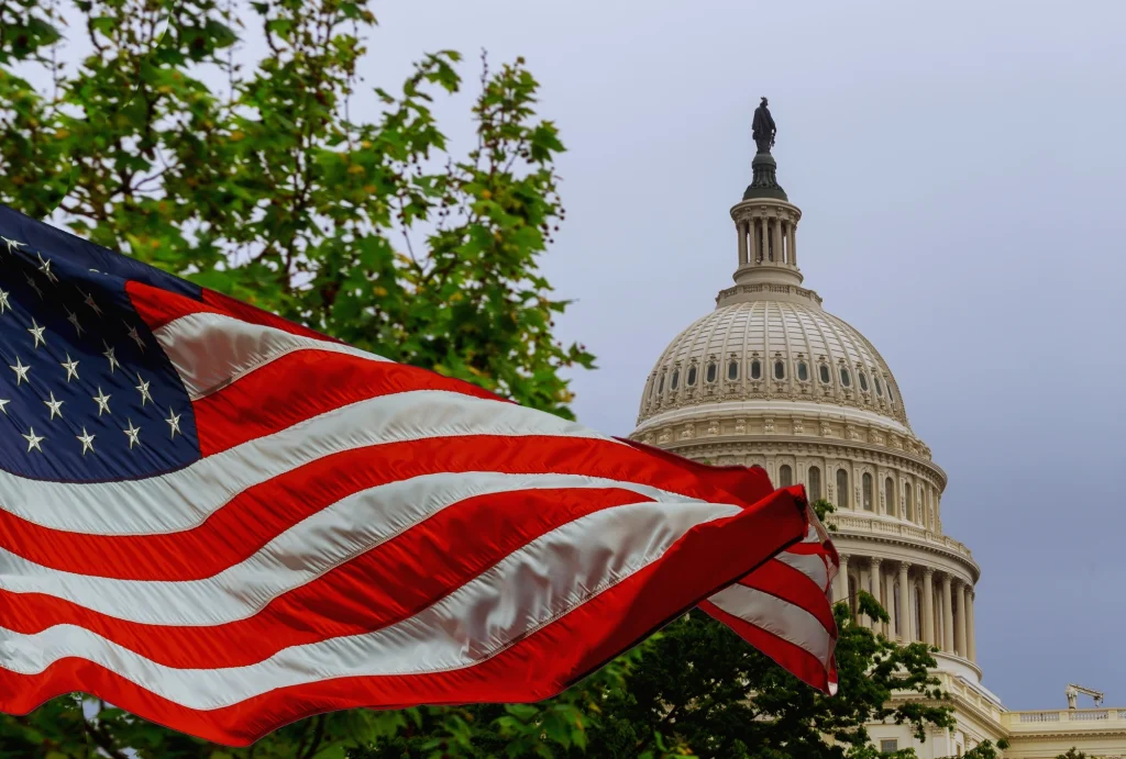 American flag waving infront of U.S. Capitol